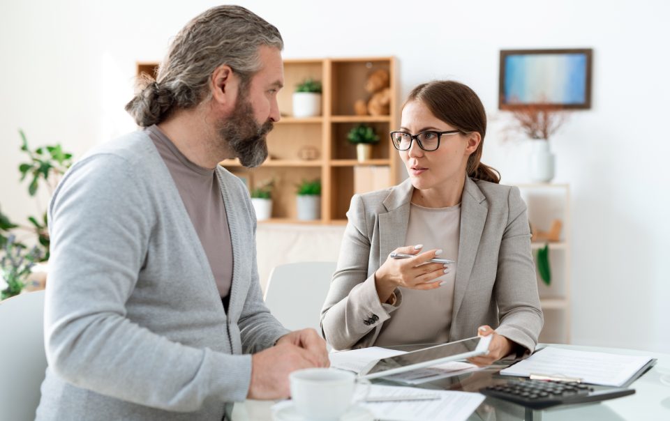 young real estate agent with touchpad explaining h ZWE8CAT