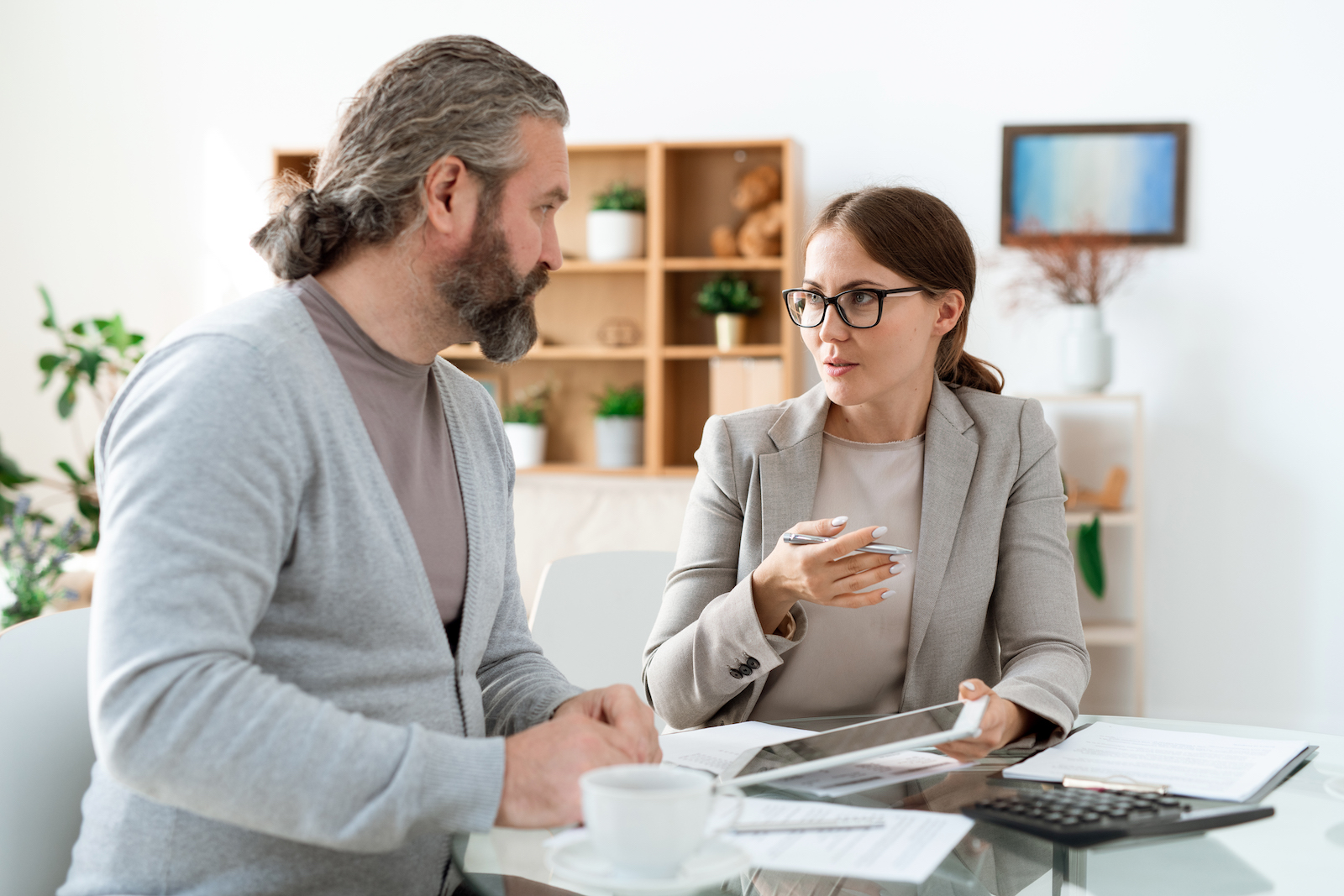 young real estate agent with touchpad explaining h ZWE8CAT