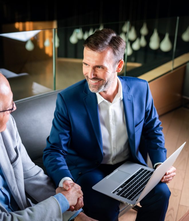 younger and older businessman shaking hands in mod UGE522P