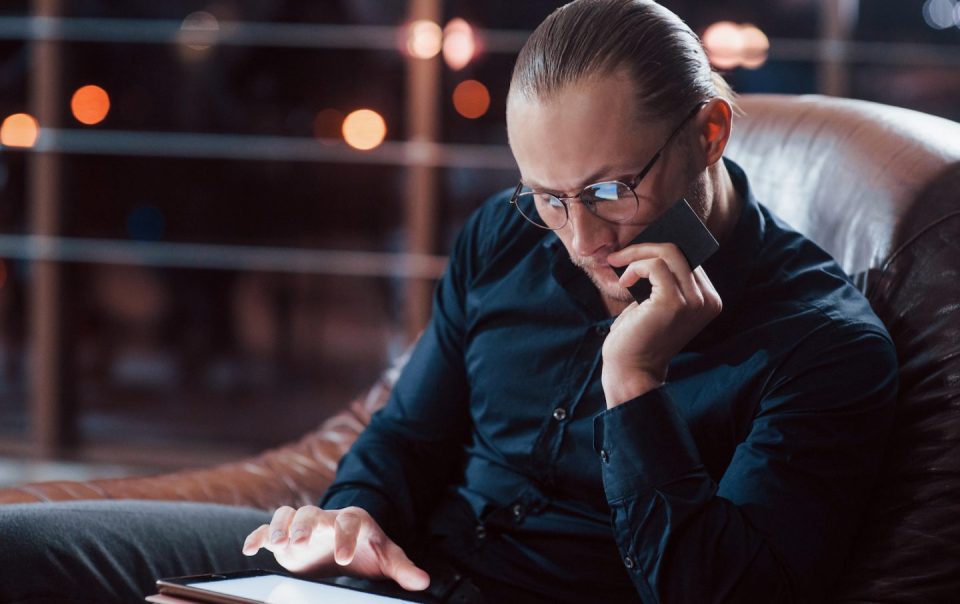 stylish businessman in eyewear works alone in the 7WFJ75G e1650789328989