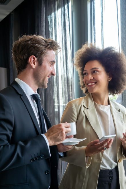 happy business colleagues talking in modern office