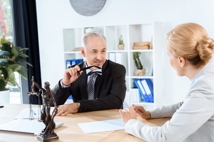 mature lawyers discussing documents in office