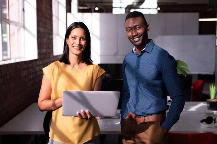 portrait of smiling diverse male and female colleague
